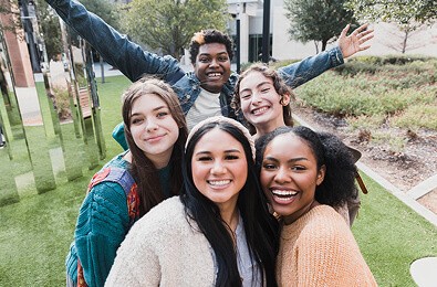 A group of smiling young women taking a selfie
